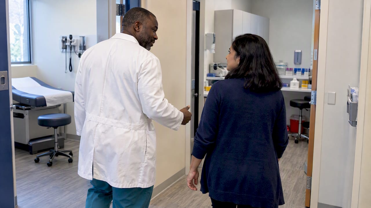 Civil surgeon guiding applicant through onsite exam clinic